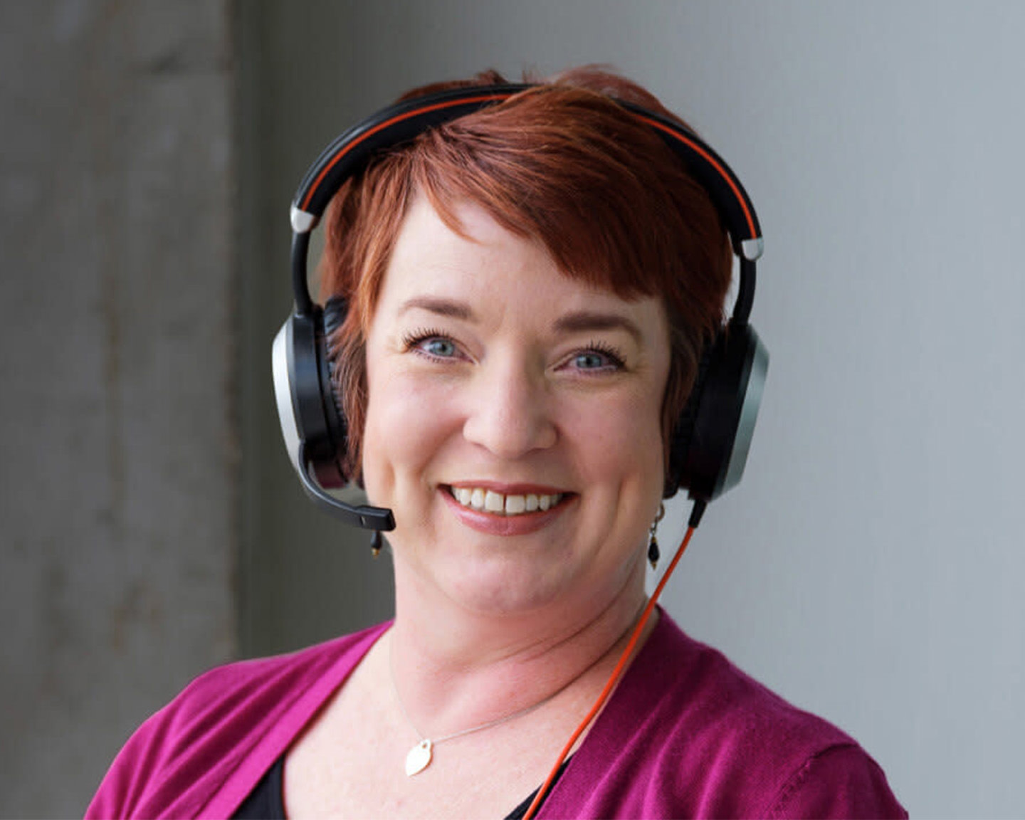 Woman with headphones on smiling to the camera