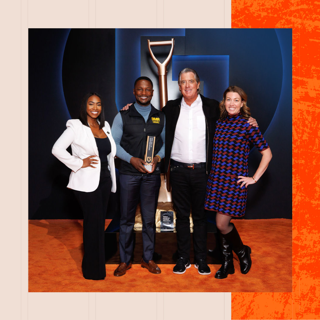 4 people holding a groundbreaker award