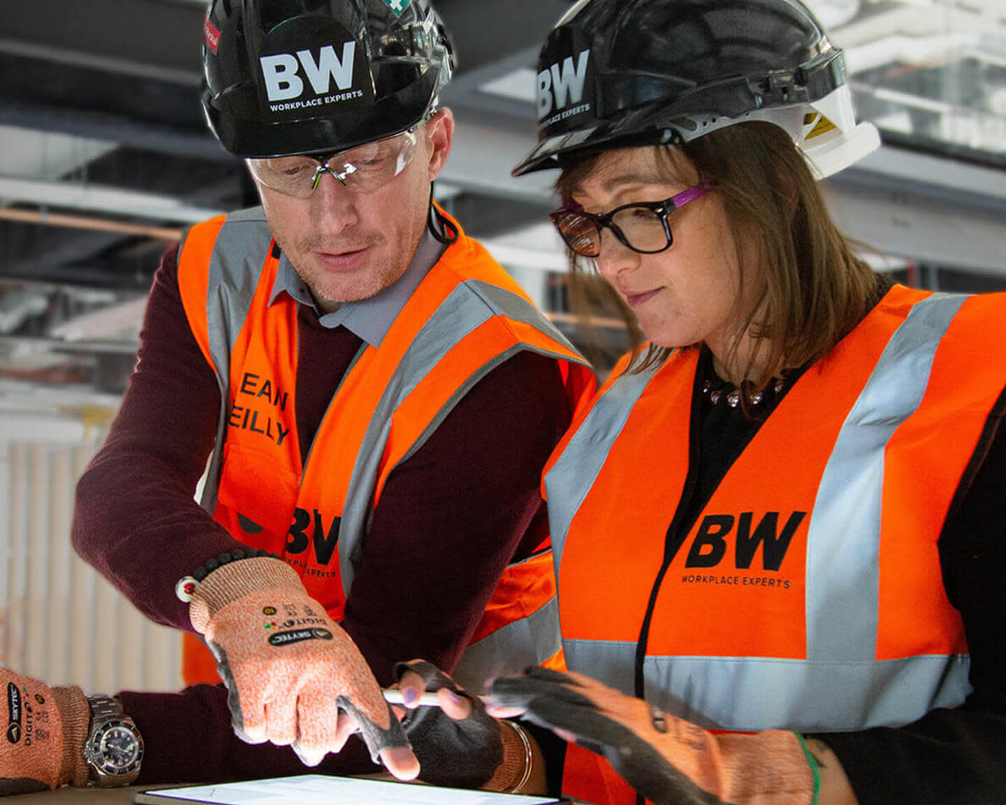 Contractors reviewing a project with Procore on a tablet