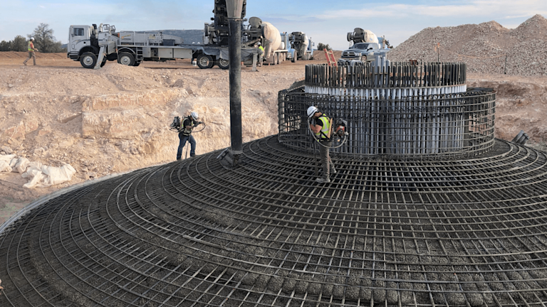 construction site with workers working on a round structure