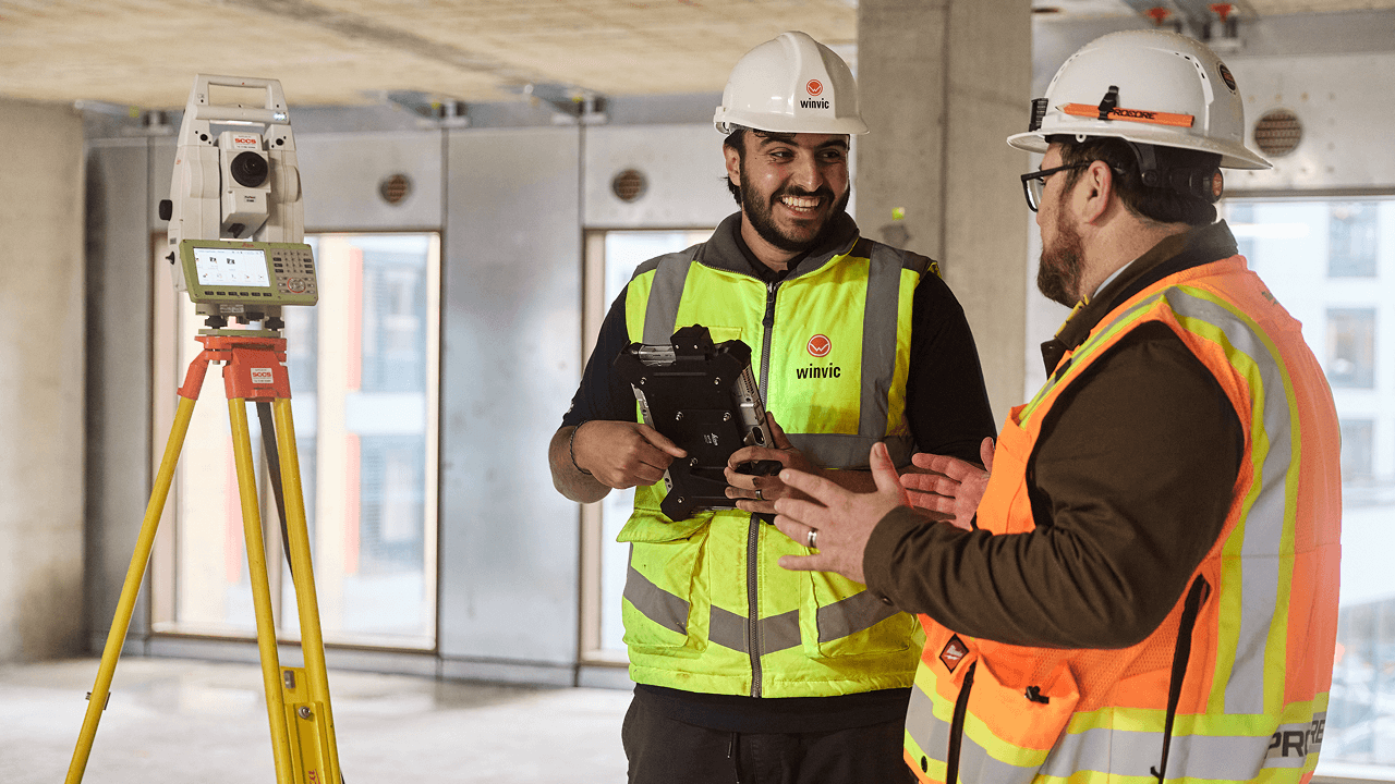 Two construction workers having a conversation on a construction site