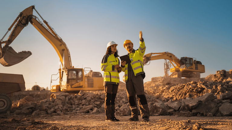 Two construction workers in discussion on site